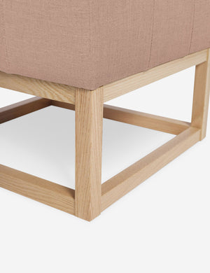 Close up of the airy wooden frame on the bottom of the Grasmere Apricot Linen Ottoman