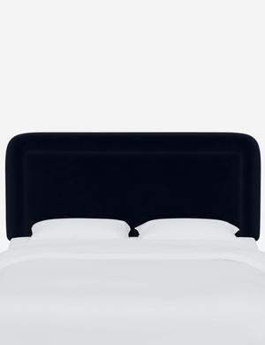 Gwendolyn Navy Velvet headboard with soft, arched corners and an interior welt border
