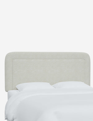 Gwendolyn White Boucle headboard with soft, arched corners and an interior welt border