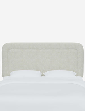 Gwendolyn White Boucle headboard with soft, arched corners and an interior welt border