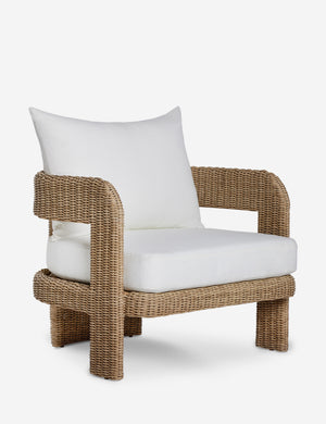 Angled view of the Hadler modern sculptural open frame wicker outdoor accent chair.