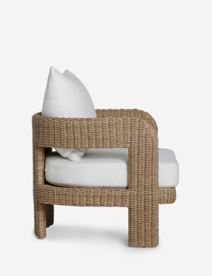Side profile of the Hadler modern sculptural open frame wicker outdoor accent chair.