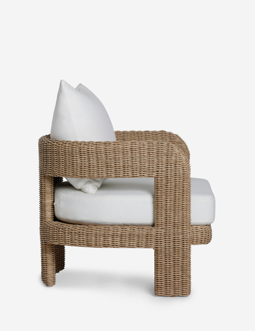 #color::natural | Side profile of the Hadler modern sculptural open frame wicker outdoor accent chair.