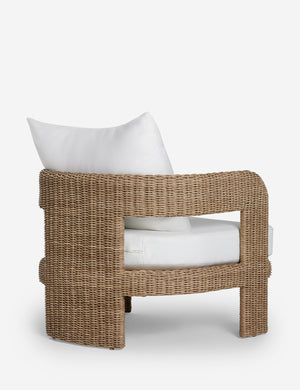Angled back view of the Hadler modern sculptural open frame wicker outdoor accent chair.