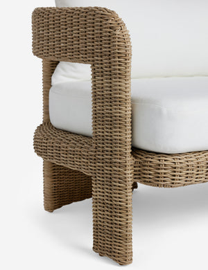 Close up of the arm of the Hadler modern sculptural open frame wicker outdoor sofa.