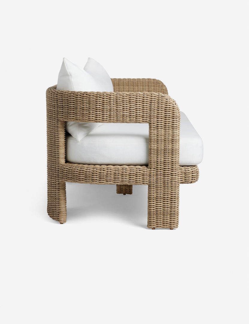 #color::natural | Side profile of the Hadler modern sculptural open frame wicker outdoor sofa.