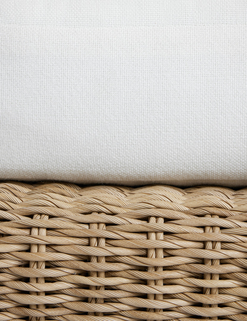 #color::natural | Close up of the seat cushion of the Hadler modern sculptural open frame wicker outdoor sofa.