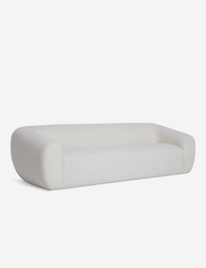Angled view of the Harlowe softly sculpted modern ivory sofa.