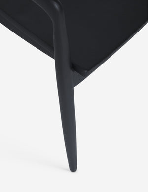The leg and seat of the Ida Black Dining Arm Chair
