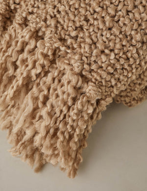 Close up of the fringe of the Jaffe chunky knit fringed outdoor throw blanket in terracotta.