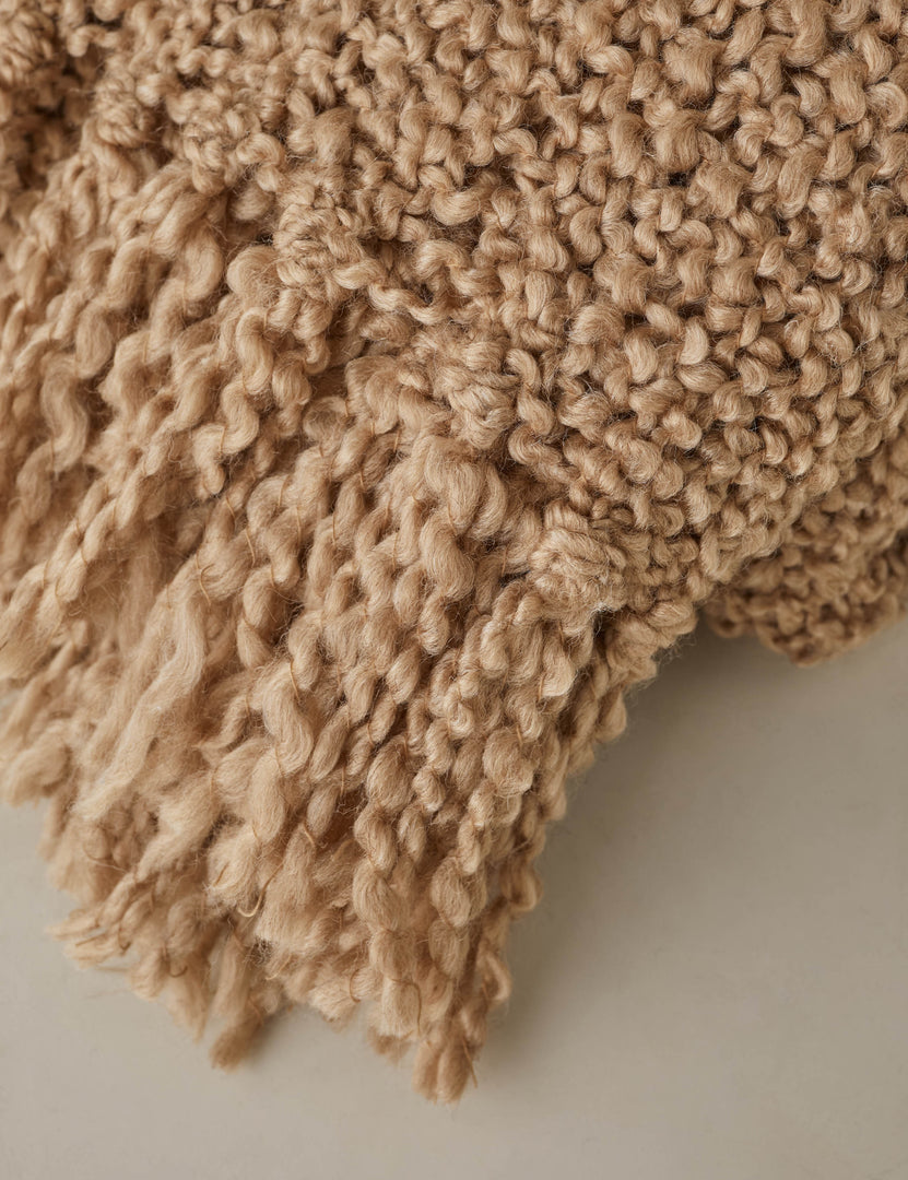 #color::terracotta | Close up of the fringe of the Jaffe chunky knit fringed outdoor throw blanket in terracotta.