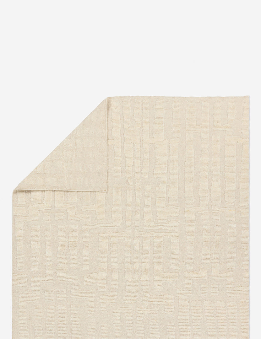 #size::6--x-9- #size::8--x-10- #size::9--x-12-#size::10--x-14- | Folded corner showing the back of the Pacheco hand-knotted wool ivory area rug.