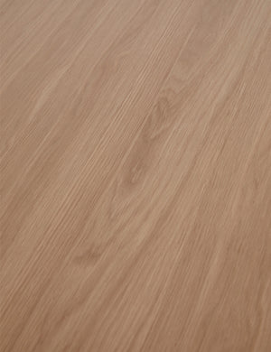 Close up view of the wood grain of the Karine round natural wood pedestal dining table