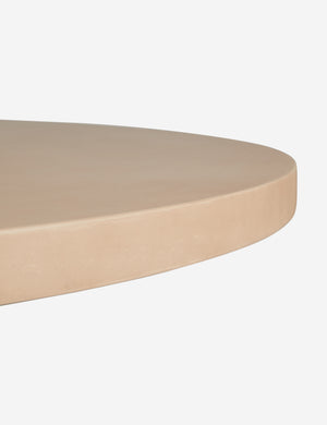 Close up of the top of the Keating sculptural round fiberstone outdoor dining table.