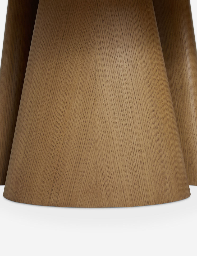 #color::russet | Close up of the base of the Keating round geometric wood pedestal dining table.