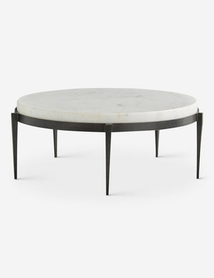 Kelsie round coffee table by Arteriors with white marble top and black five-leg base