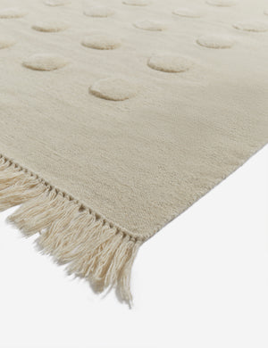 Corner of the Kohta high-low pile dot design wool area rug in ivory