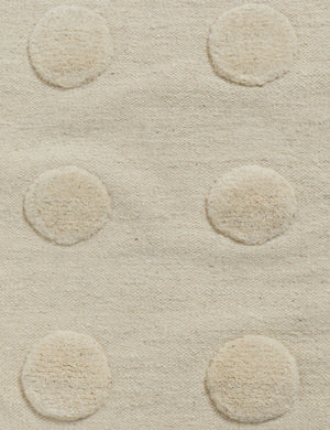 Close up of the Kohta high-low pile dot design wool area rug in ivory