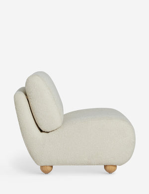 Side profile of the Kya textural boucle armless accent chair.