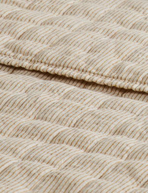 Close up of the Lammin striped quilted linen coverlet in goldenrod and ivory
