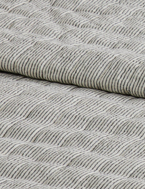 Close up of the Lammin striped quilted linen coverlet in black and ivory