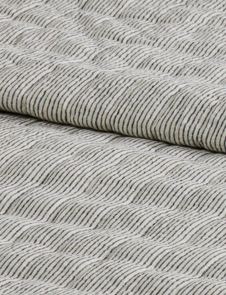 #color::black-and-ivory #size::full-queen #size::king-cal-king | Close up of the Lammin striped quilted linen coverlet in black and ivory