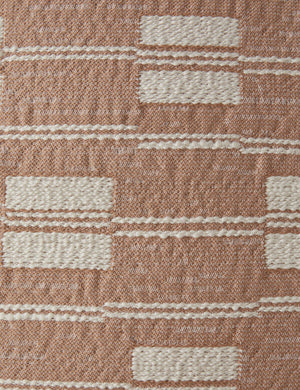Close up of the Leighton broken stripe pillow in terracotta.