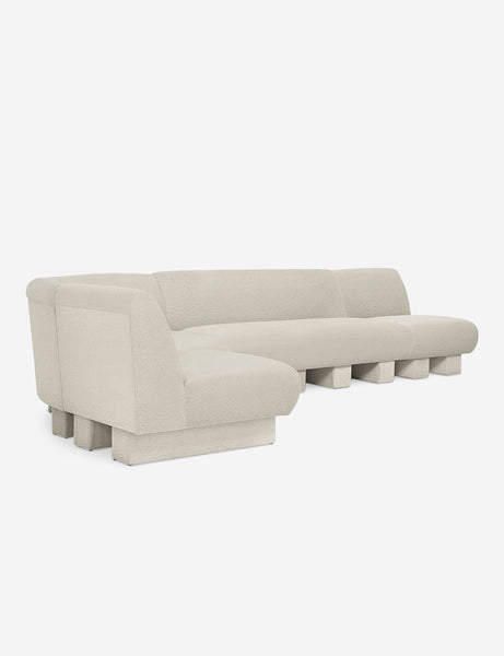 #color::Ivory-Boucle #configuration::left-facing #size::142-W | Angled view of the Lena left-facing white boucle sectional sofa with upholstered beam legs.