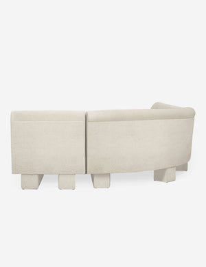Rear view of the side of the Lena right-facing white boucle sectional sofa with upholstered beam legs.