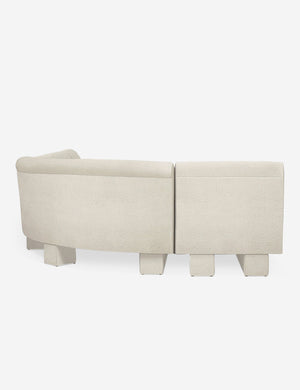 Rear view of the side of the Lena left-facing white boucle sectional sofa with upholstered beam legs.