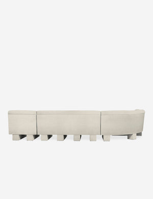 Rear view of the entire Lena left-facing white boucle sectional sofa with upholstered beam legs.