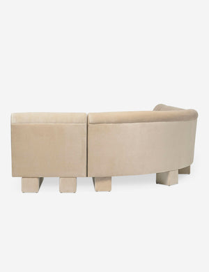 Rear view of the side of the Lena left-facing beige velvet sectional sofa with upholstered beam legs.