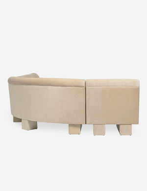 Rear view of the side of the Lena right-facing beige velvet sectional sofa with upholstered beam legs.