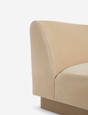 Side view of the  Centerpiece of the Lena beige velvet sectional sofa with upholstered beam legs
