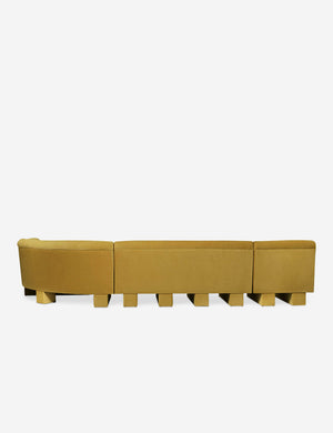 Rear view of the side of the Lena right-facing yellow velvet sectional sofa with upholstered beam legs.