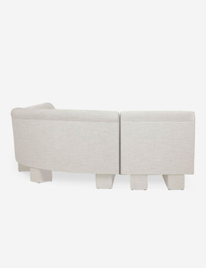 Rear view of the side of the Lena right-facing natural linen sectional sofa with upholstered beam legs.