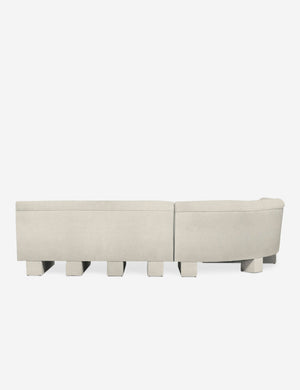 Rear view of the entire Lena right-facing white boucle sectional sofa with upholstered beam legs.