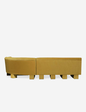 Rear view of the entire Lena right-facing yellow velvet sectional sofa with upholstered beam legs.