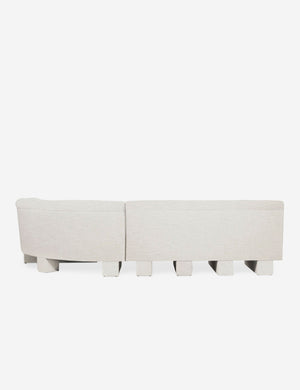 Rear view of the entire Lena right-facing natural linent sectional sofa with upholstered beam legs.