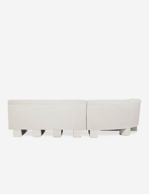 Rear view of the entire Lena left-facing natural linen sectional sofa with upholstered beam legs.