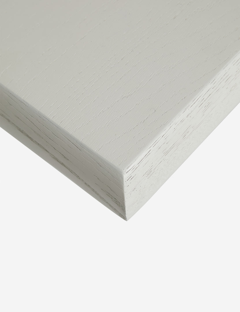 #color::white-wash | Close up of the corner of the Lowen double pedestal base white washed dining table.