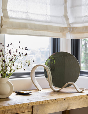 Round Wavee Table Mirror by SIN Ceramics styled on a table