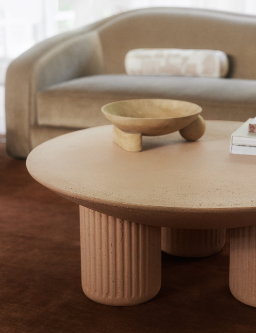 #color::terracotta | Carr modern round fluted base coffee table styled with a dark rose solid color rug.