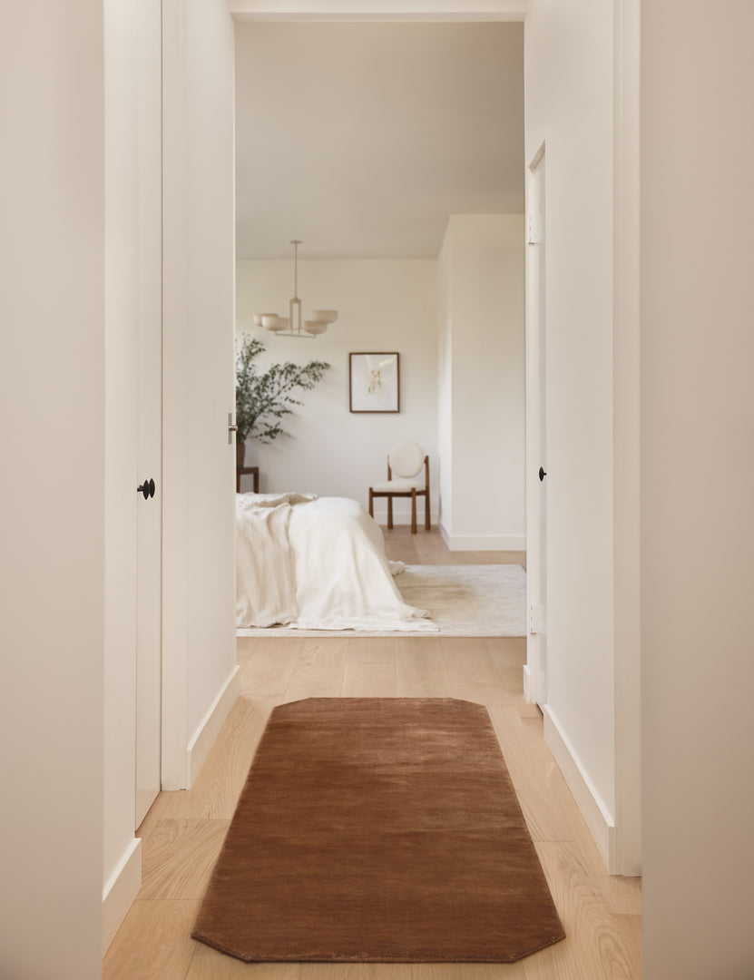 #color::rose #size::2-6--x-8--runner | Hallway to a bedroom featuring the Damara solid viscose runner rug in rose.
