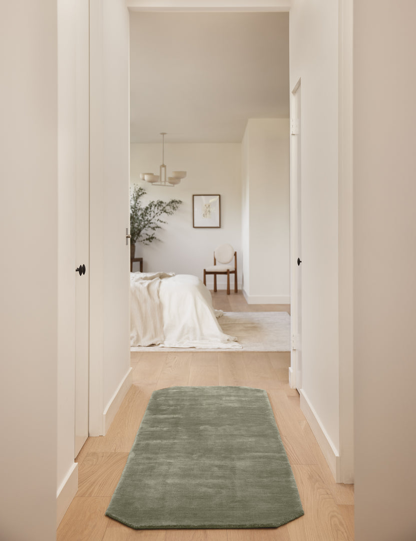 #color::sage #size::2-6--x-8--runner | Hallway to a bedroom featuring the Damara solid viscose runner rug in sage.