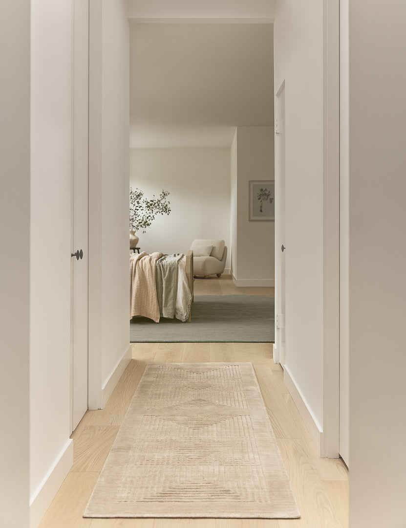 #size::2-6--x-8--runner | Hallway to a bedroom featuring the Halden handwoven carved design runner rug.