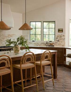 Two Terrene Woven Rattan Pendant by Elan Byrd hanging above a kitchen island.