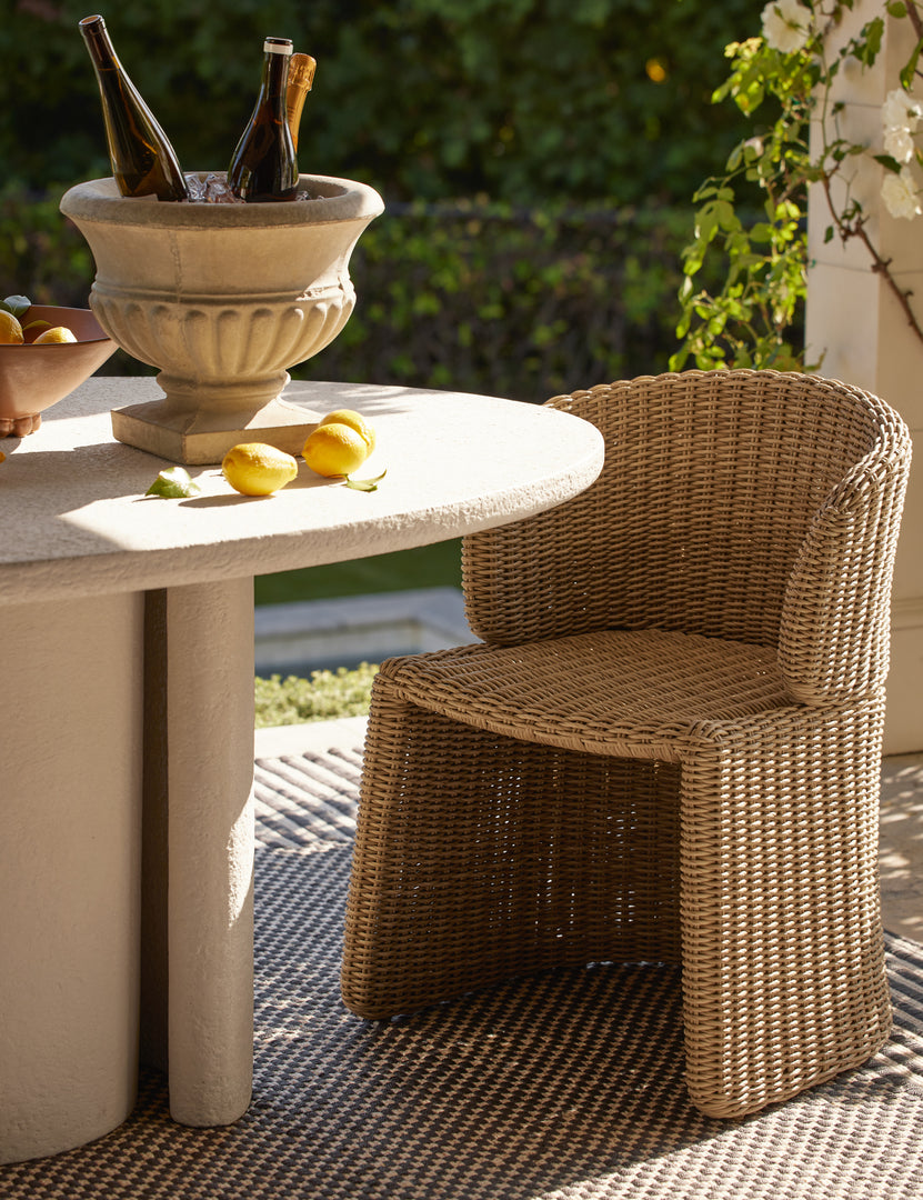 #color::natural | Mettam modern wicker outdoor dining chair styled by a oval outdoor dining table.