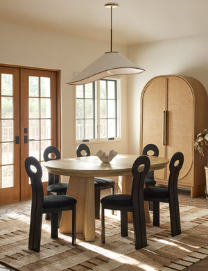 Arroyo Mixed-Material Pendant Light by Elan Byrd hanging above a dining table.