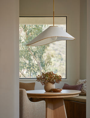 Arroyo Mixed-Material Pendant Light by Elan Byrd hanging above a table in a dining nook.